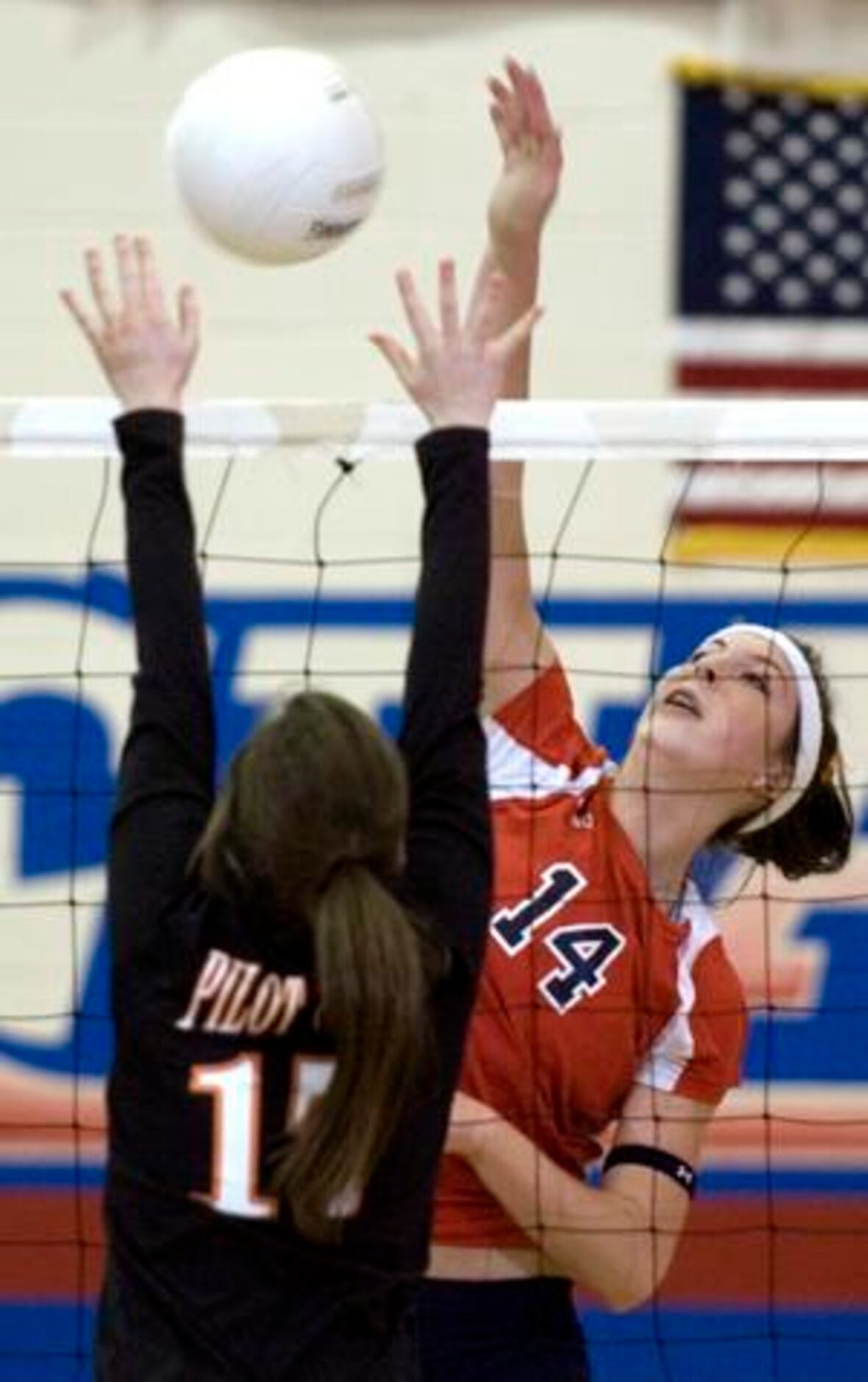 Aubrey's Jac Bullock (14) spikes against Pilot Point's Ashley Bullard (17) during a District...