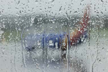 A plane seen on the tarmac through a window as rain falls at Dallas Love Field on Thursday,...