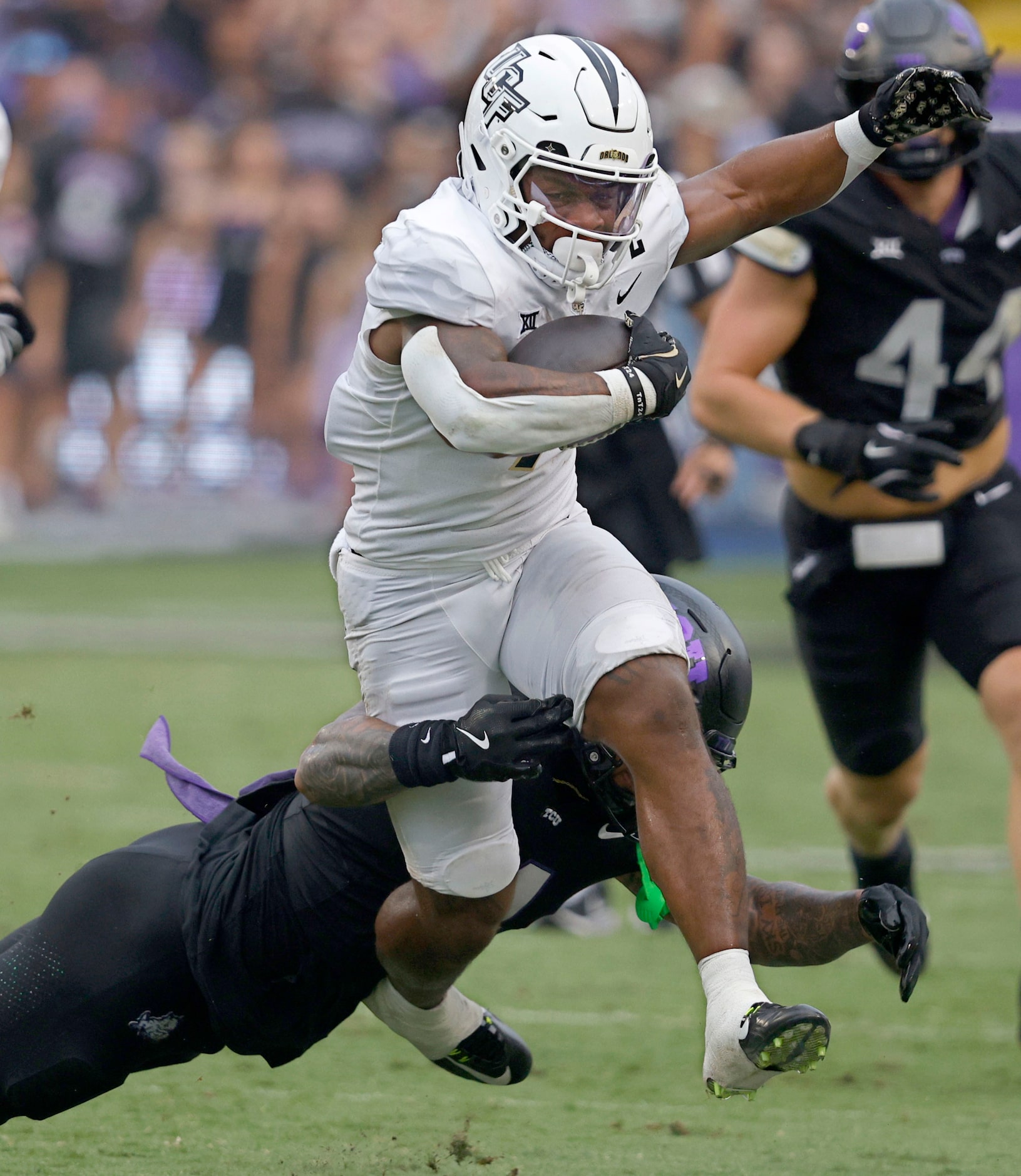 UCF running back RJ Harvey (7) is tackled by TCU linebacker Namdi Obiazor (4) during the...