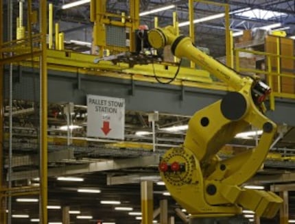  The Robo-Stow moves pallets from level to level at the Amazon.com fulfillment center in...