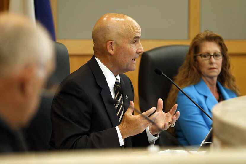 Collin County Judge Keith Self (center) speaks during a hearing on the resolution on illegal...