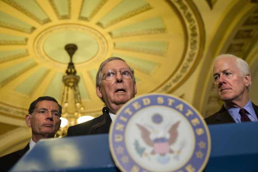 
Senate Majority Leader Mitch McConnell of Kentucky, center, flanked by Sen. John Barrasso,...