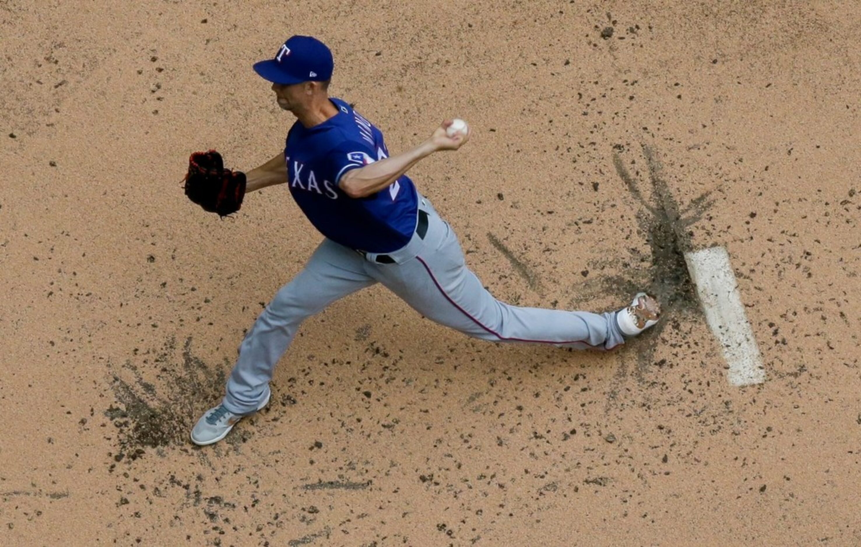 Texas Rangers starting pitcher Mike Minor throws during the first inning of a baseball game...