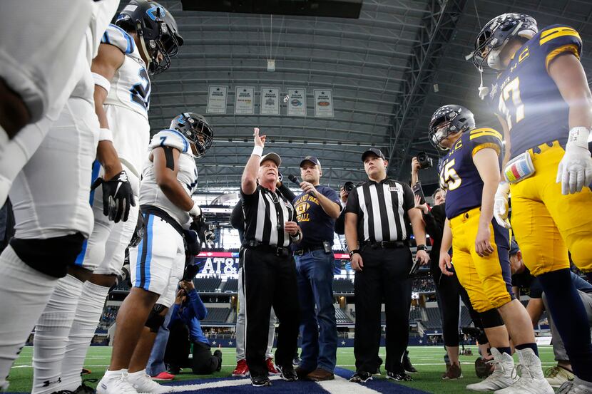 The referee tosses the coin before Highland Park and Shadow Creek's play the Class 5A...