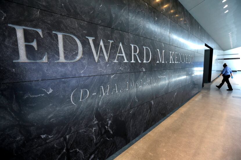 In this 2015 file photo, a passer-by walks near the engraved name of the late U.S. Sen....