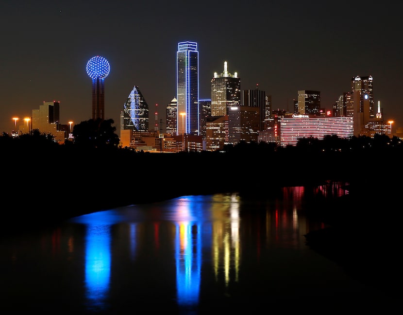 Downtown's Bank of America Plaza, center, and other buildings were turned blue to honor...