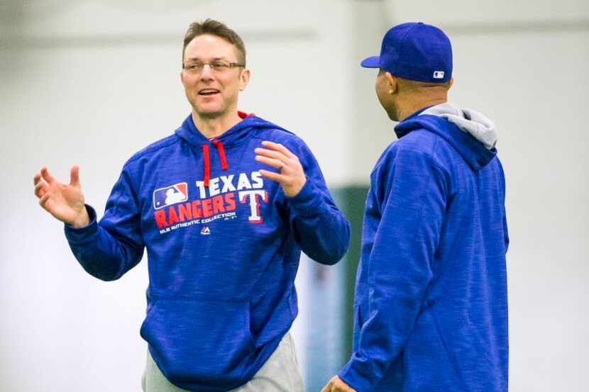 Texas Rangers hitting coach Anthony Iapoce (left) chats with third base coach Tony Beasley...