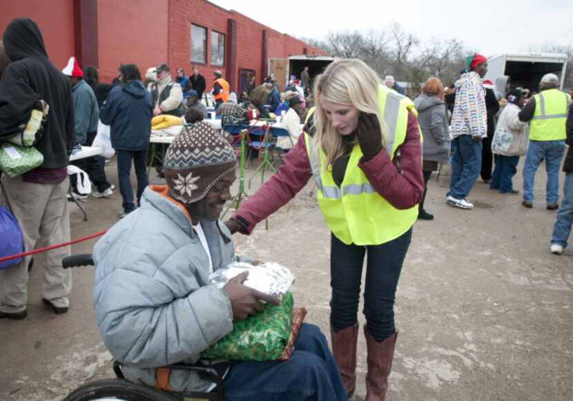 Kelly Ann Scott, a volunteer, gave Bob Johnson a wrapped plate of food to go with his gifts...
