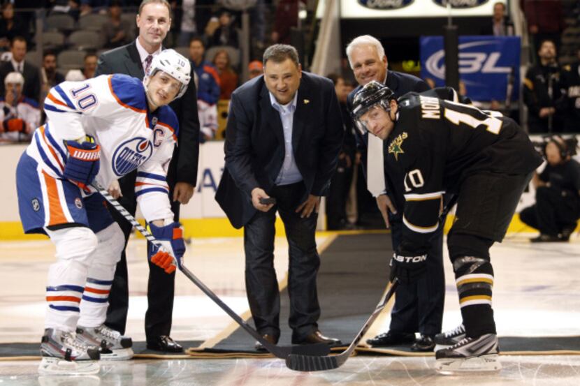 Stars owner Tom Gaglardi drops the first puck with Edmonton center Shawn Horcoff (left) and...