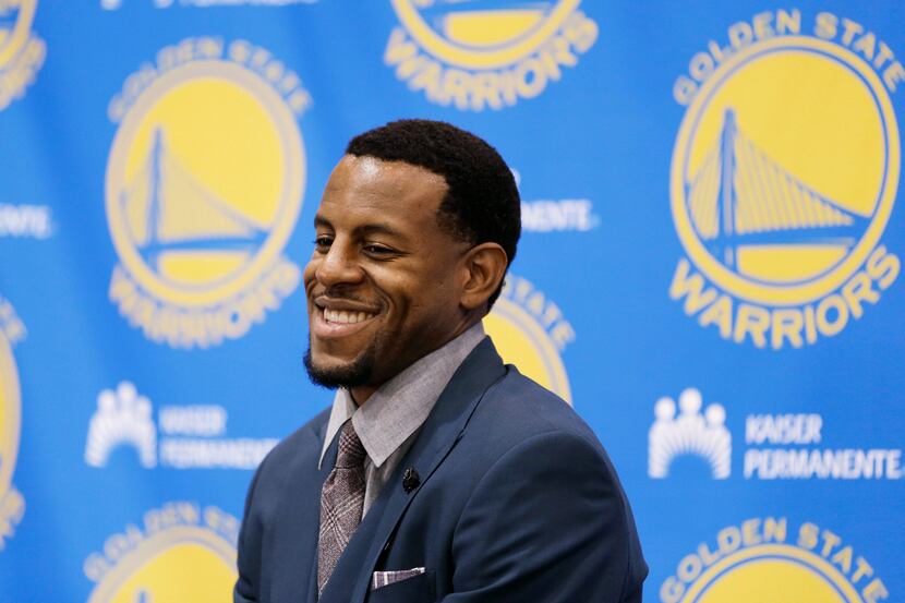 Andre Iguodala smiles before being introduced by the Golden State Warriors NBA basketball...