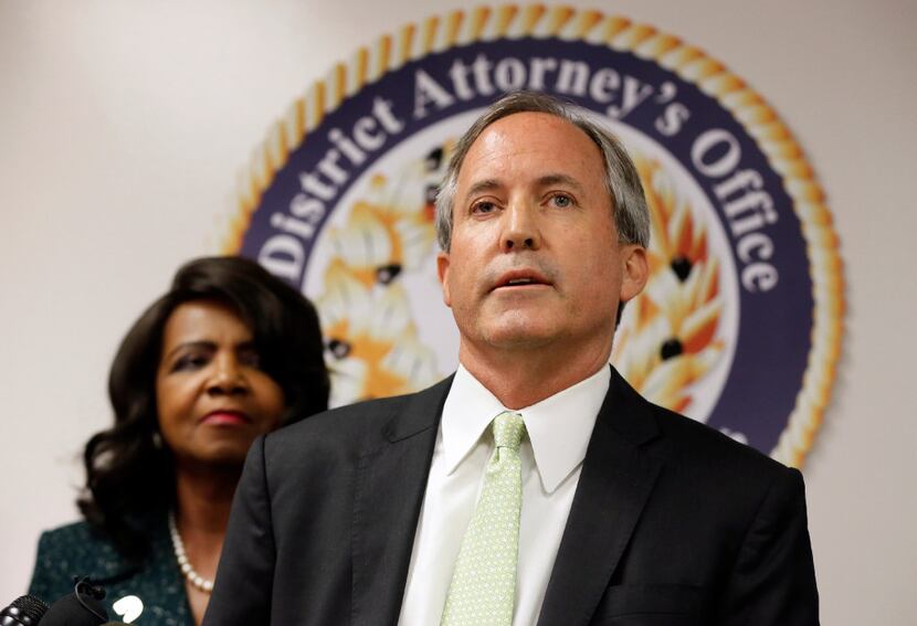 In this June 2017 file photo, Texas Attorney General Ken Paxton, center, makes comments...