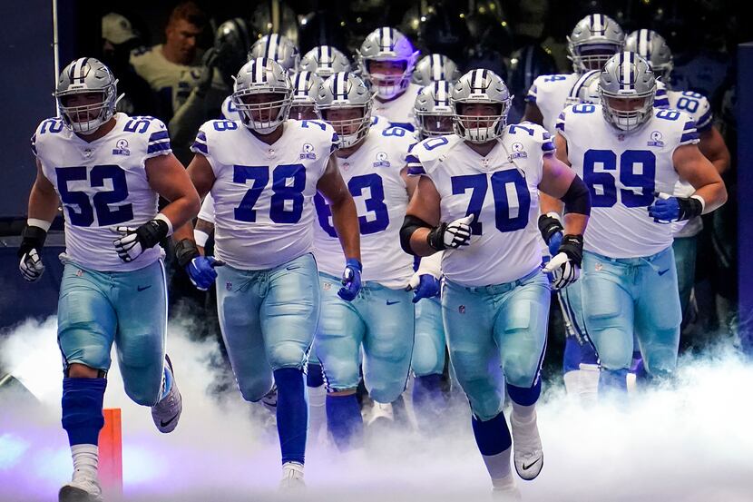 Dallas Cowboys offensive guard Zack Martin (70) leads the team onto the field to face the...