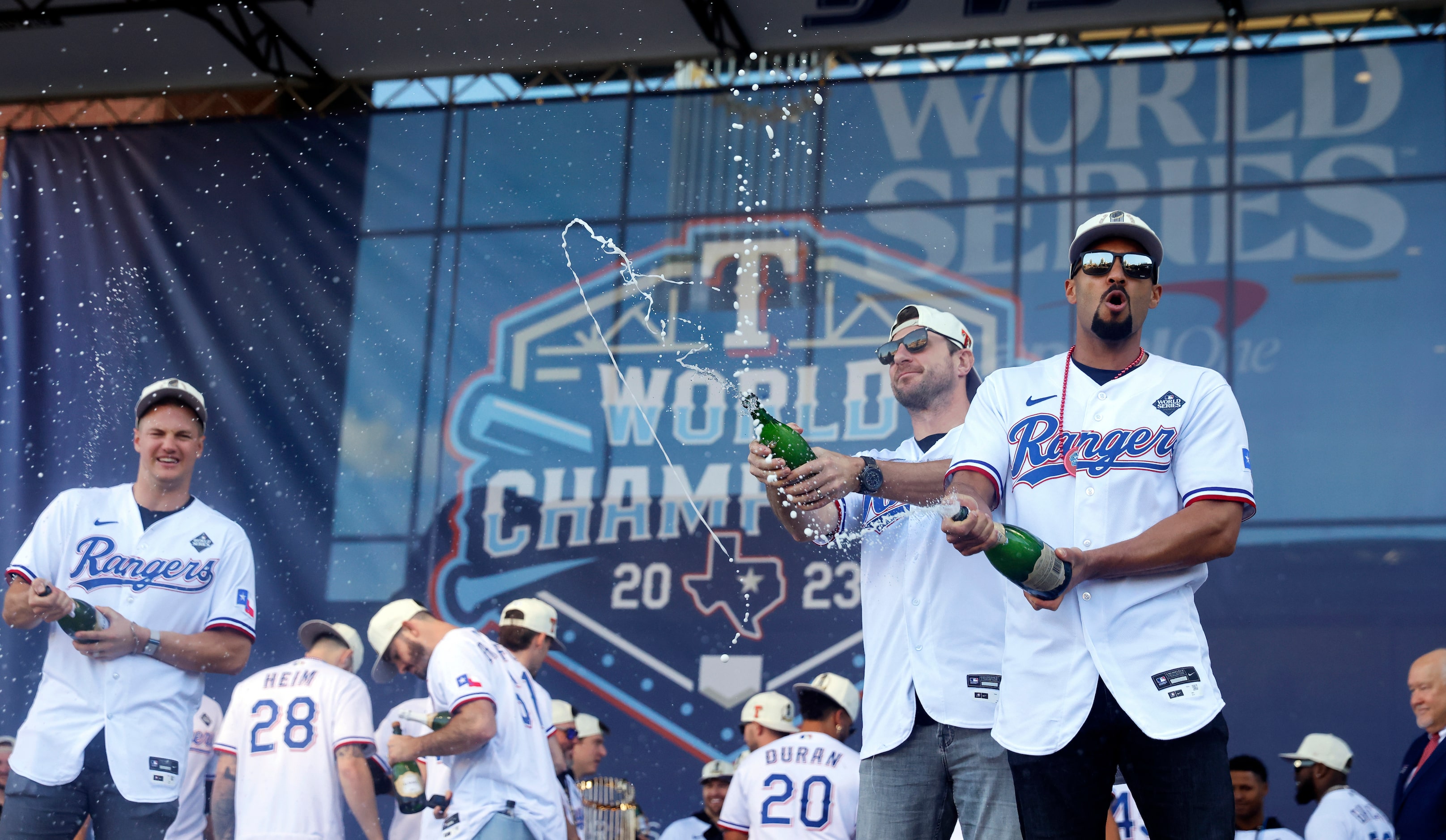 Texas Rangers second baseman Marcus Semien (right) and starting pitcher Max Scherzer (second...