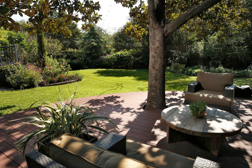 
In back, Wicker added a shady deck with lounges, a koi pond and an outdoor dining room...