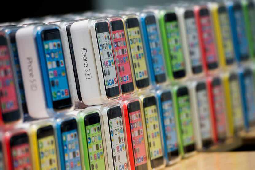 Apple Inc. iPhone 5c devices are displayed during the launch at the company's new Stanford...