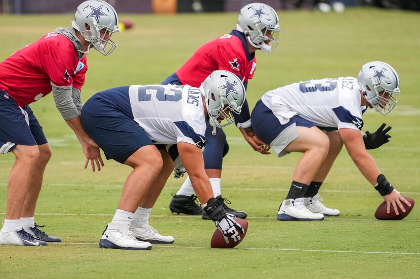 Dallas Cowboys guard Connor Williams (52) works at center with Tyler Biadasz (63) and...