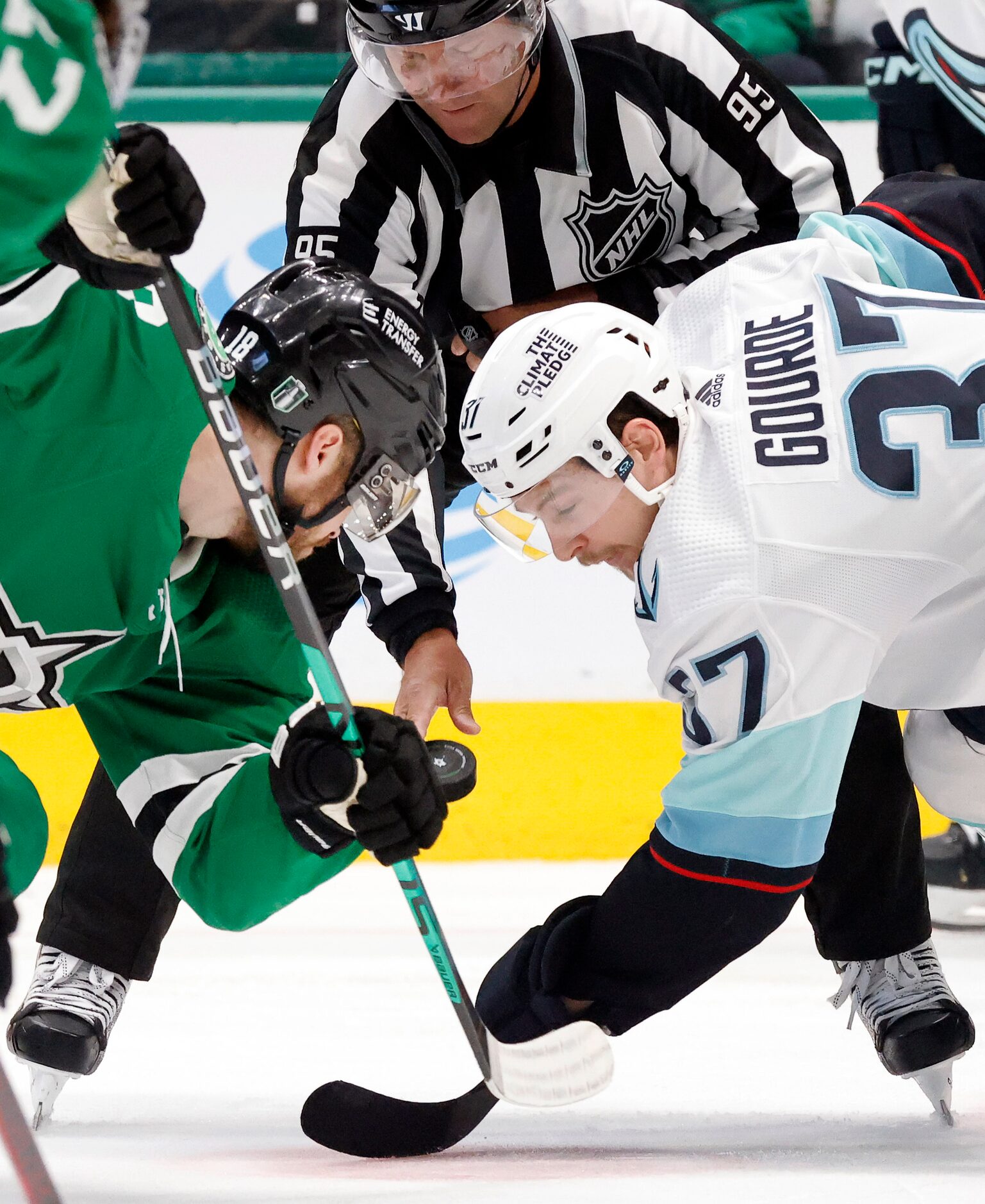 Dallas Stars center Max Domi (18) faces off against Seattle Kraken center Yanni Gourde (37)...