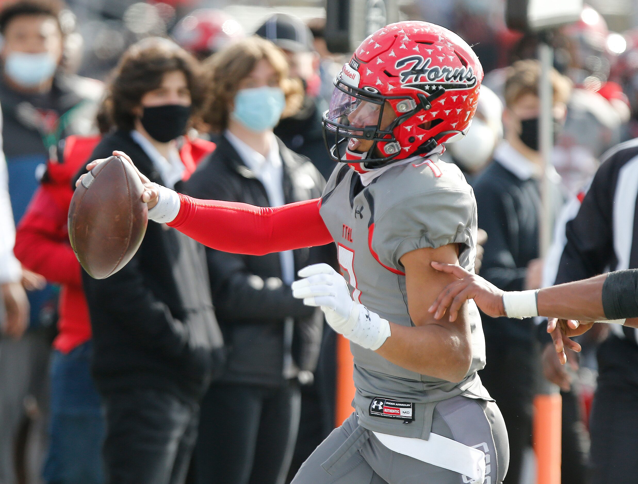 Cedar Hill High School quarterback Kaidon Salter (7) extends the ball for extra yardage as...