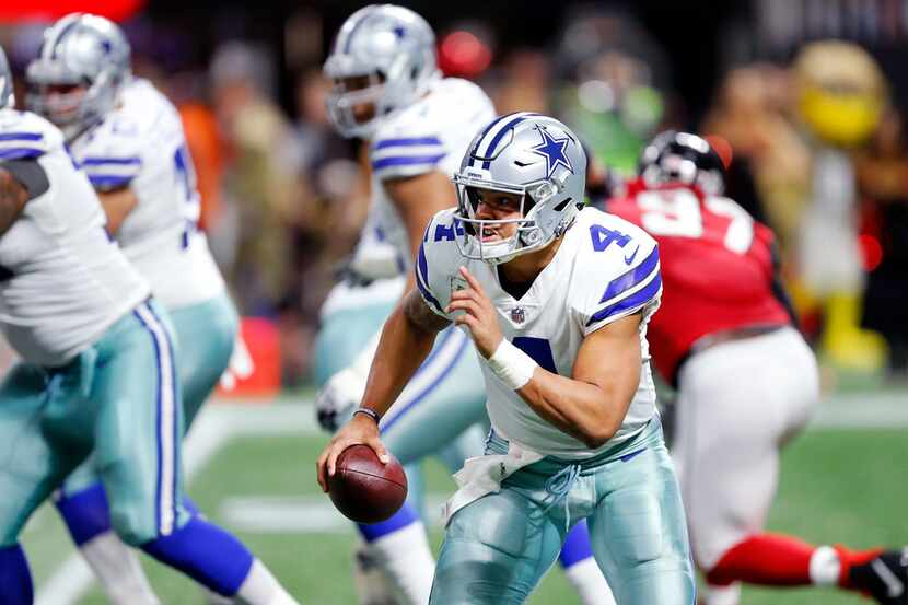 Dallas Cowboys quarterback Dak Prescott (4) rushes with the ball in the second quarter...