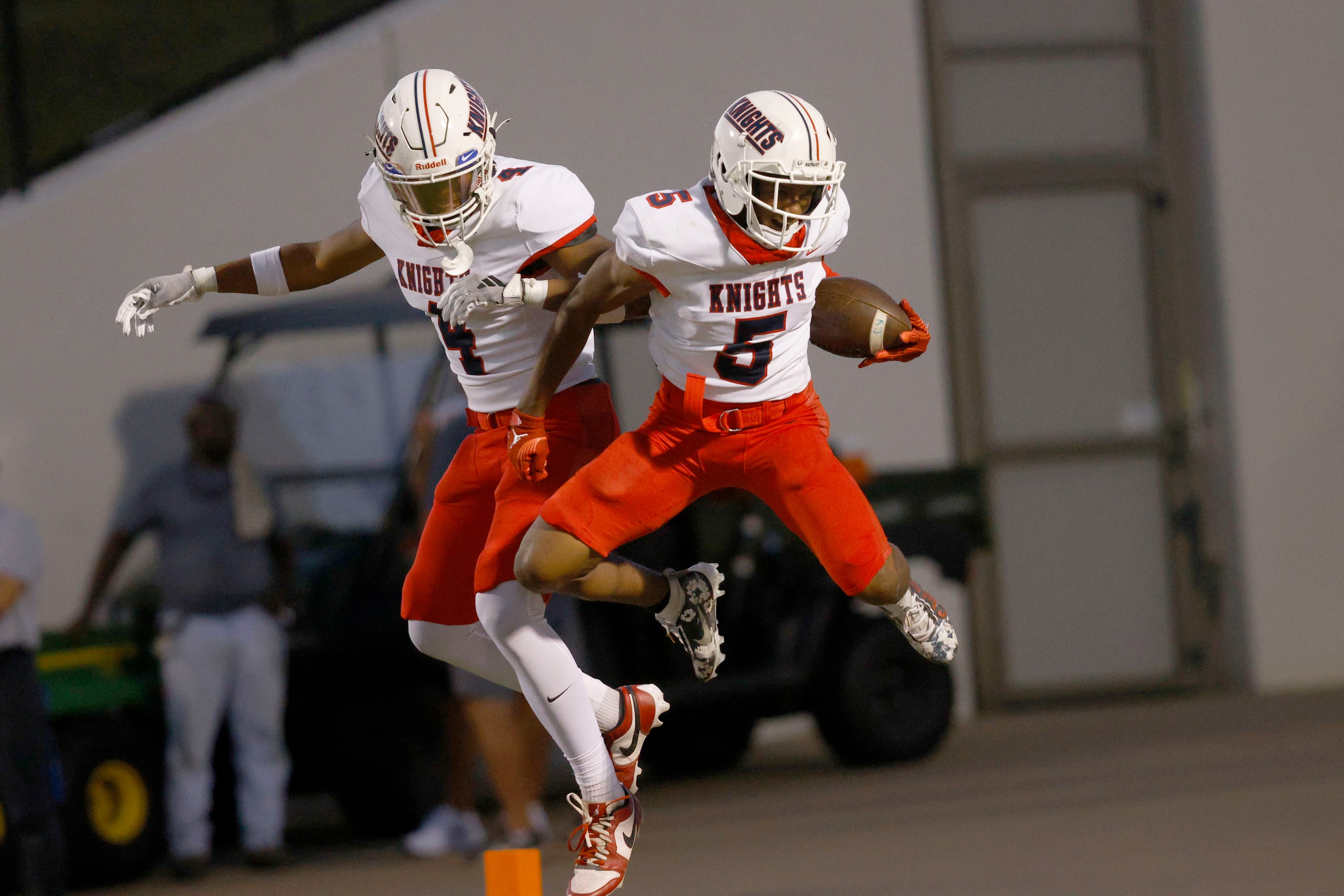 Kimball's Camrin Jackson (5) celebrates with his teammate Jaylen Mosley (4) after scoring a...