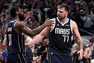 Dallas Mavericks' Kyrie Irving (11) and Luka Doncic, right, celebrate the team's win in Game...