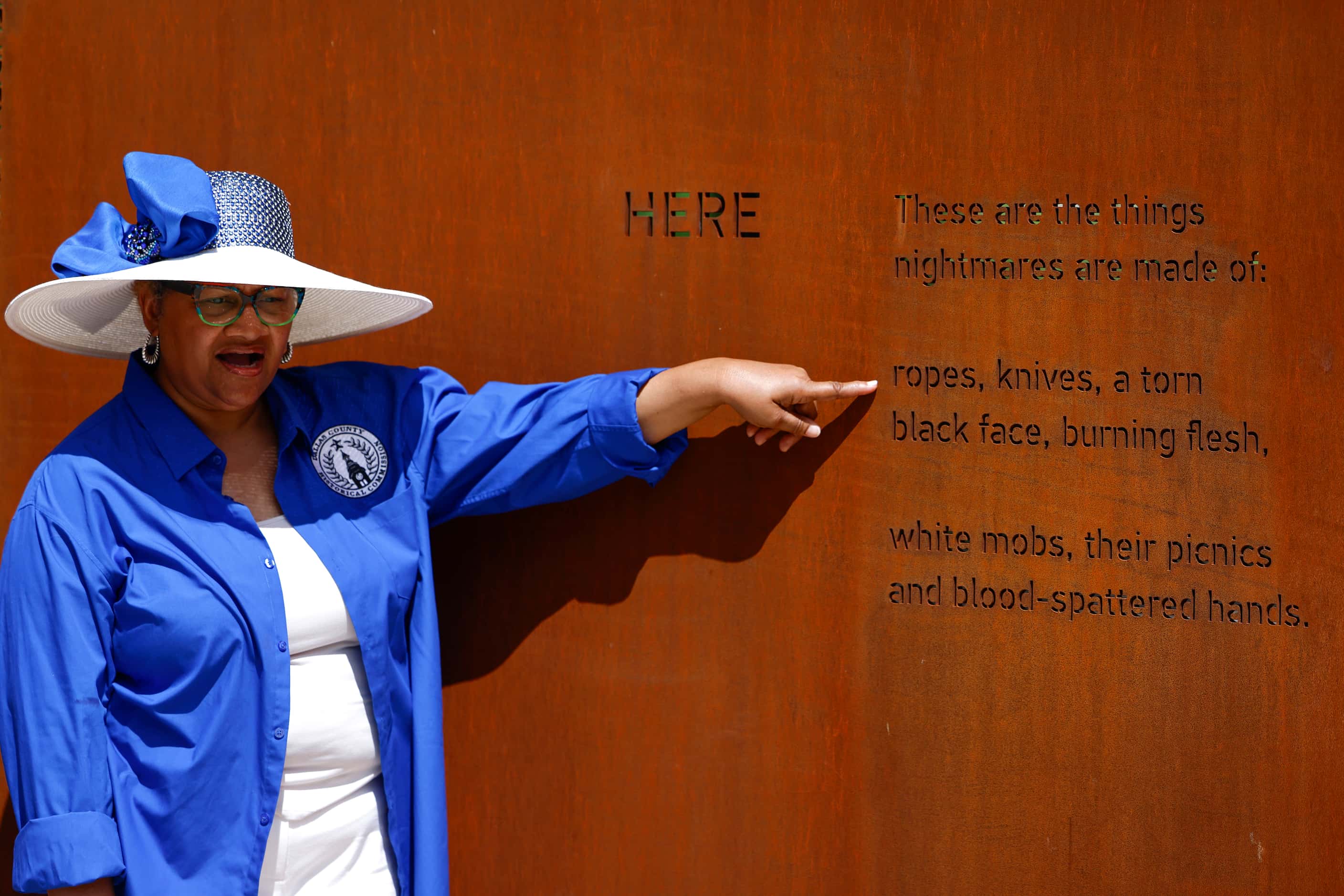 Patricia Hicks, vice chair of the Dallas County Historical Commission, points at the...