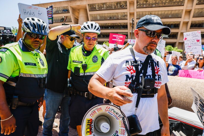 Abortion rights supporters and opponents clash while demonstrating in downtown Dallas on...