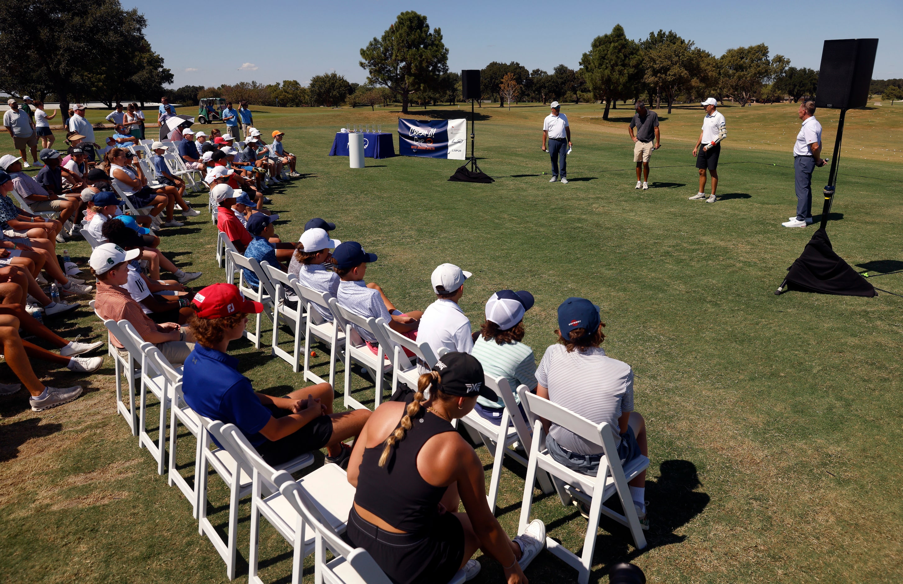 PGA Tour pro Jordan Spieth (second from right) speaks to junior golfers alongside his...