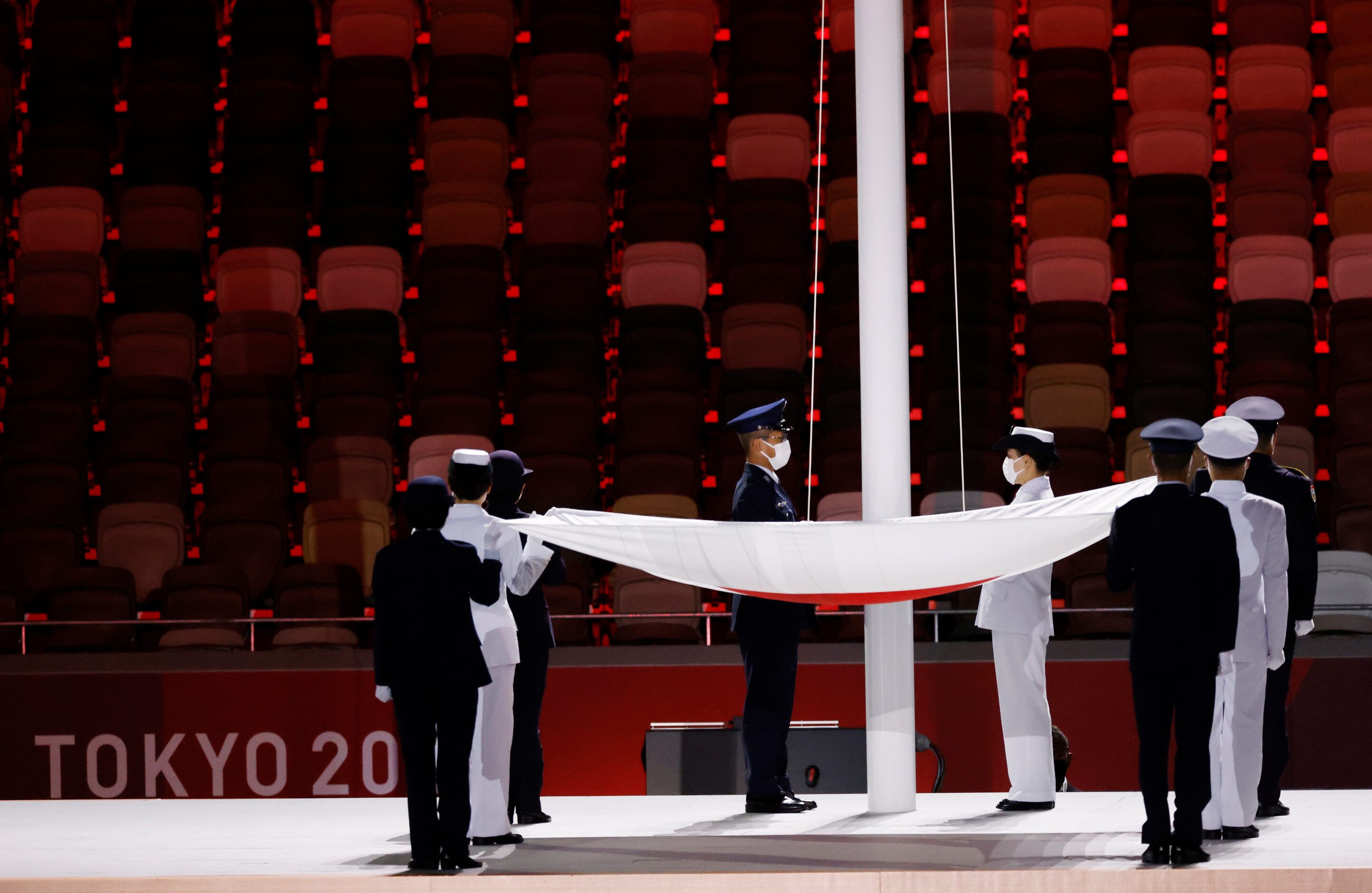 The flag of Japan is raised during the opening ceremony for the postponed 2020 Tokyo...