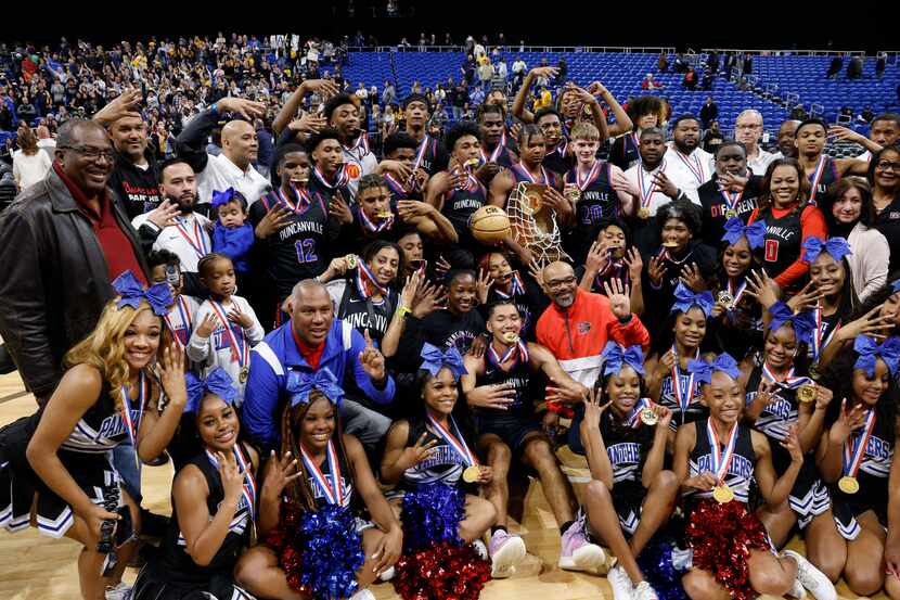 Duncanville players, cheerleaders and staff pose for photos after winning the Class 6A state...