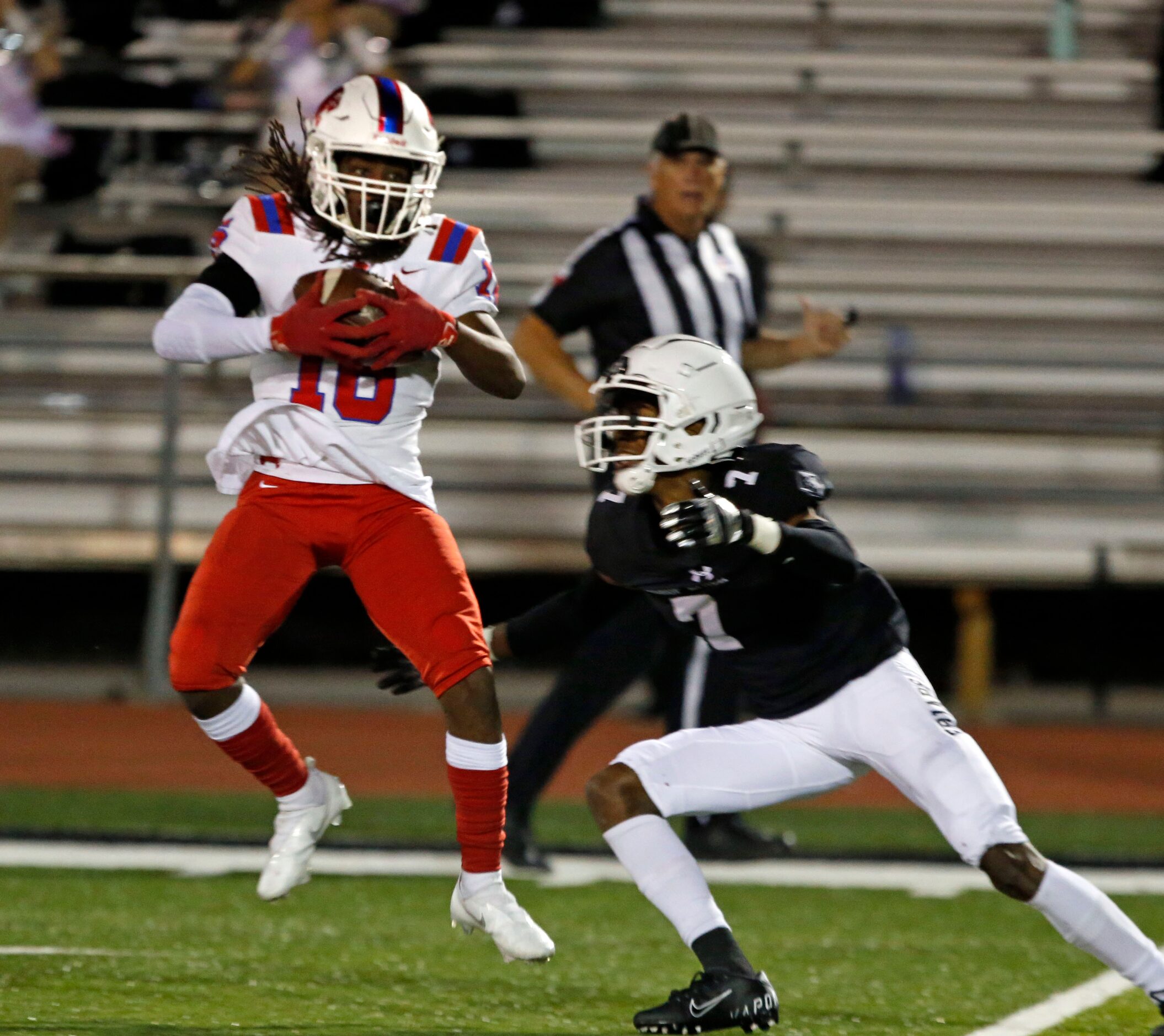 Episcopal defender Isaiah Johnson (16) makes an interception in front of Bishop Lynch’s...