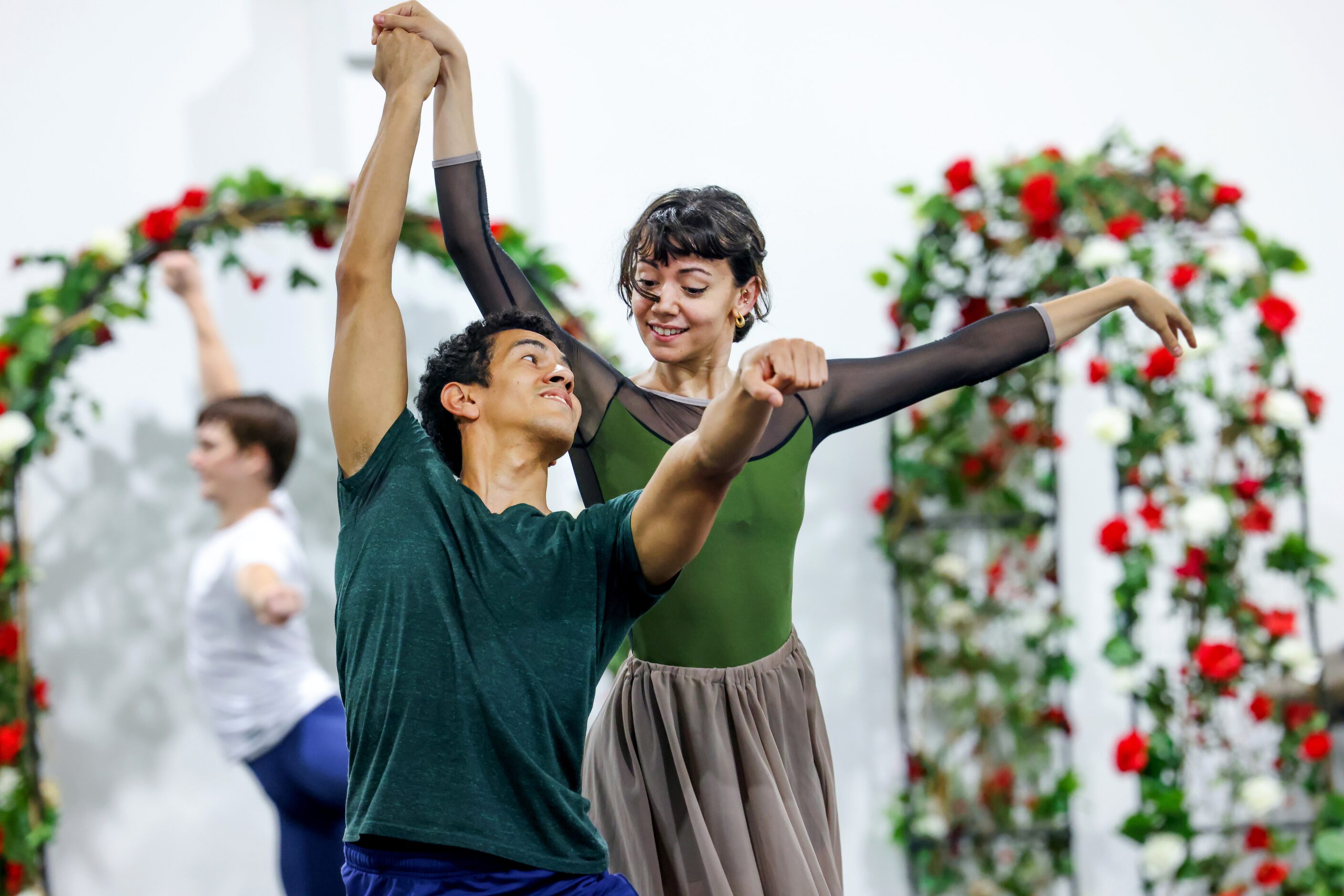 Alexandra F. Light (right) takes the hand of Joamanuel Velazquez as they rehearse a portion...