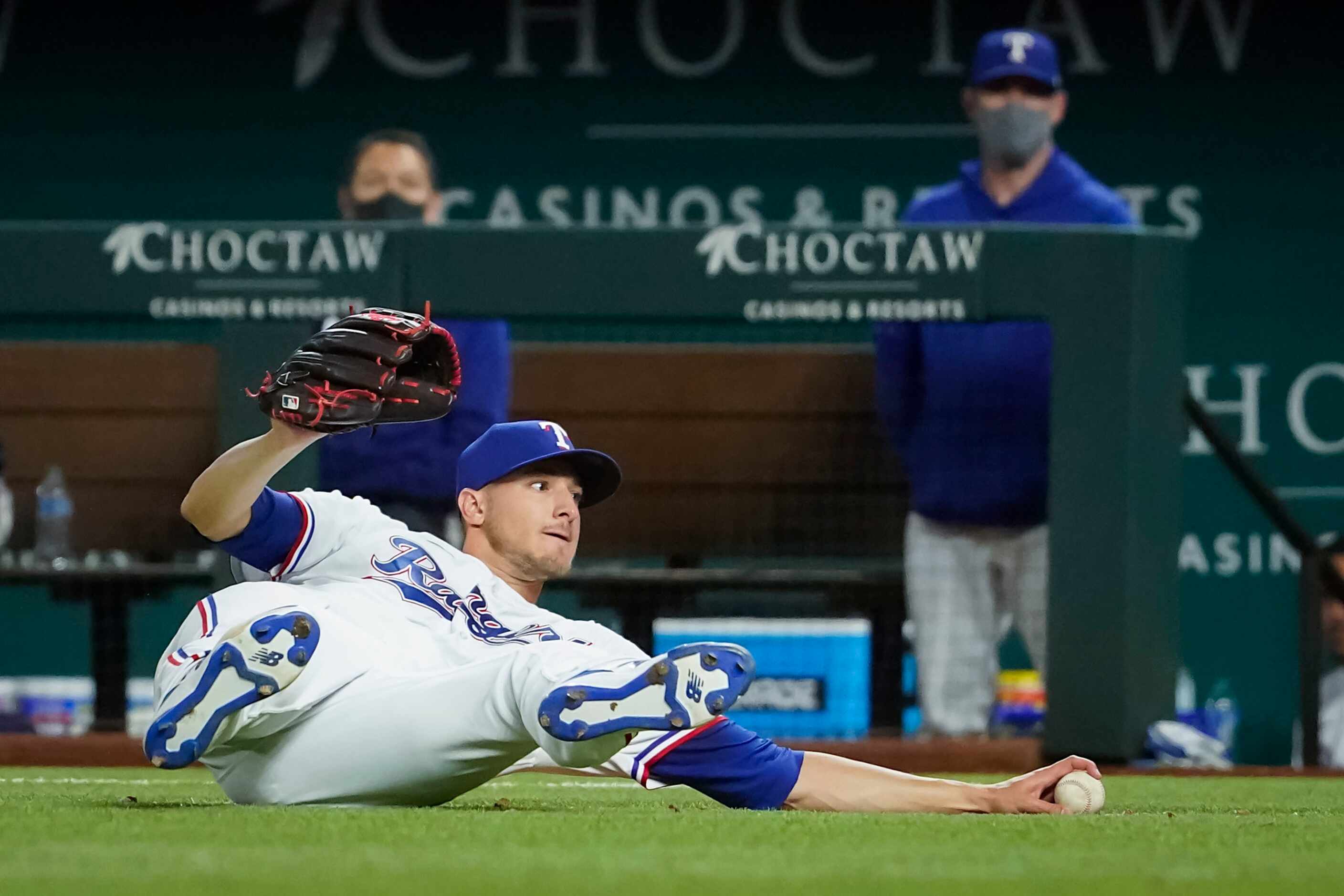 Texas Rangers pitcher Brett Martin can’t make the play on a single off the bat of San Diego...