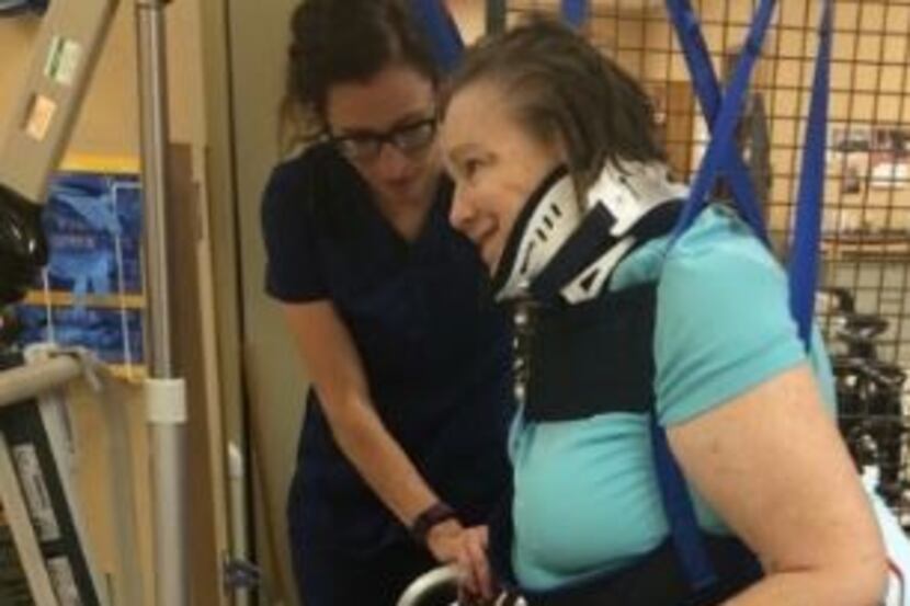 Debbie Ransom taking her first steps in therapy several months after the shooting.