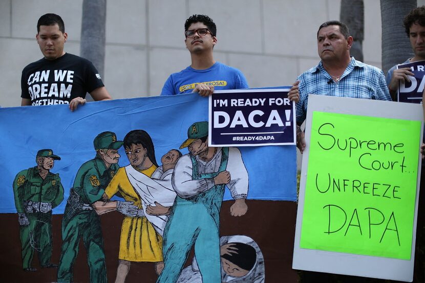  Immigrant families and their supporters stand together during a news conference to speak...