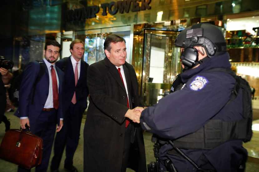 Sen. Ted Cruz greets police as he leaves Trump Tower on Tuesday night.