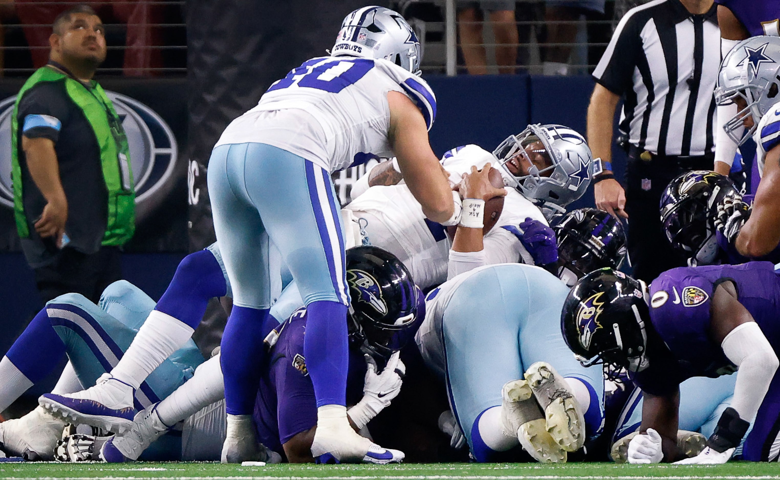 Dallas Cowboys quarterback Dak Prescott (4) lays over a pile of players and goal line for a...