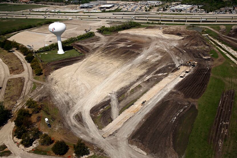  Work crews are already building new roads to access the site for Liberty Mutual's new Plano...