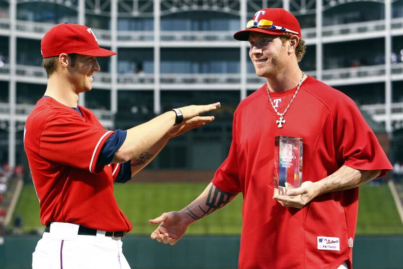 Texas Rangers C.J. Wilson, left, shows he not worthy after presenting the Players Choice...
