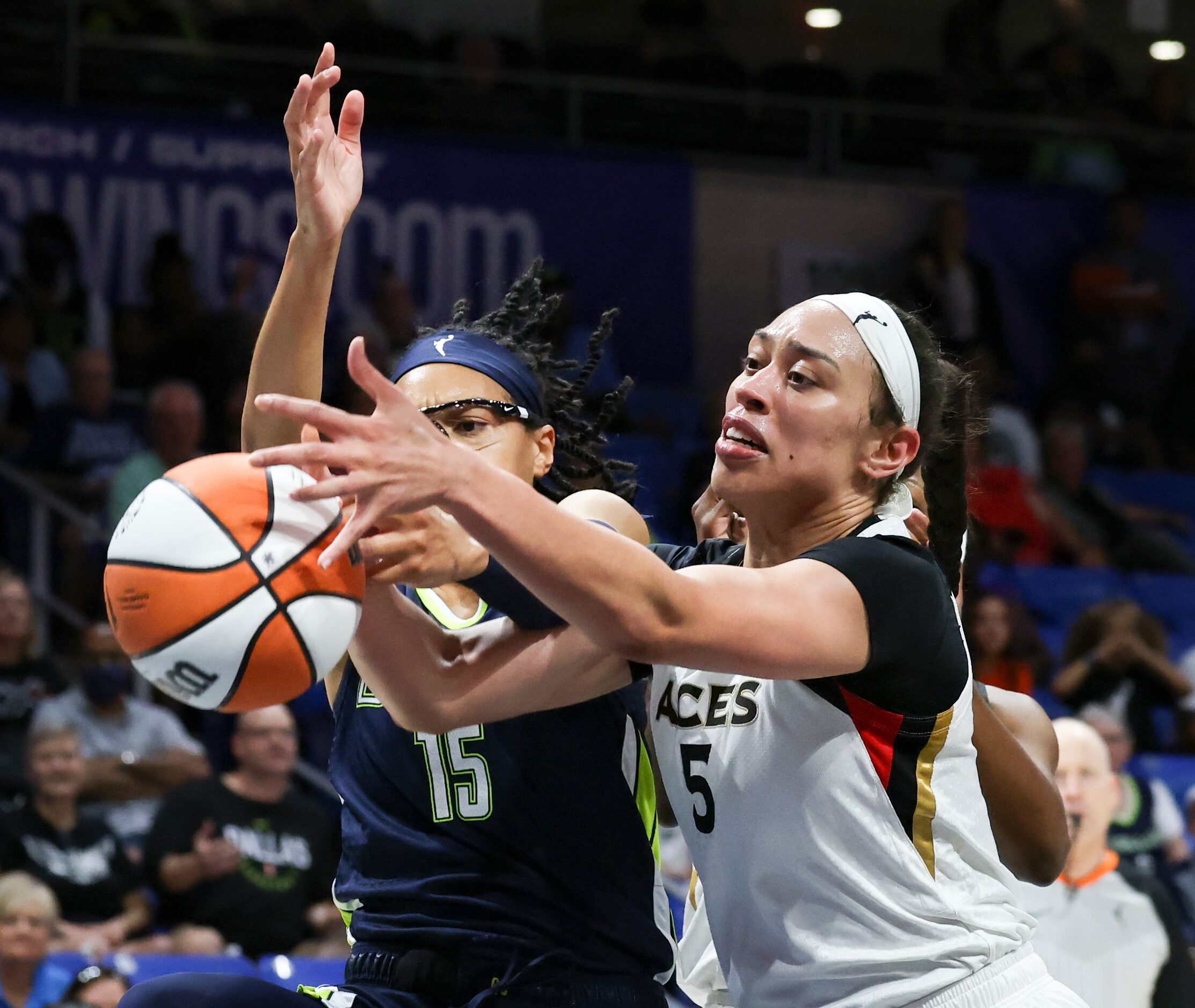 Dallas Wings guard Allisha Gray (15) and Las Vegas Aces forward Dearica Hamby (5) reach for...