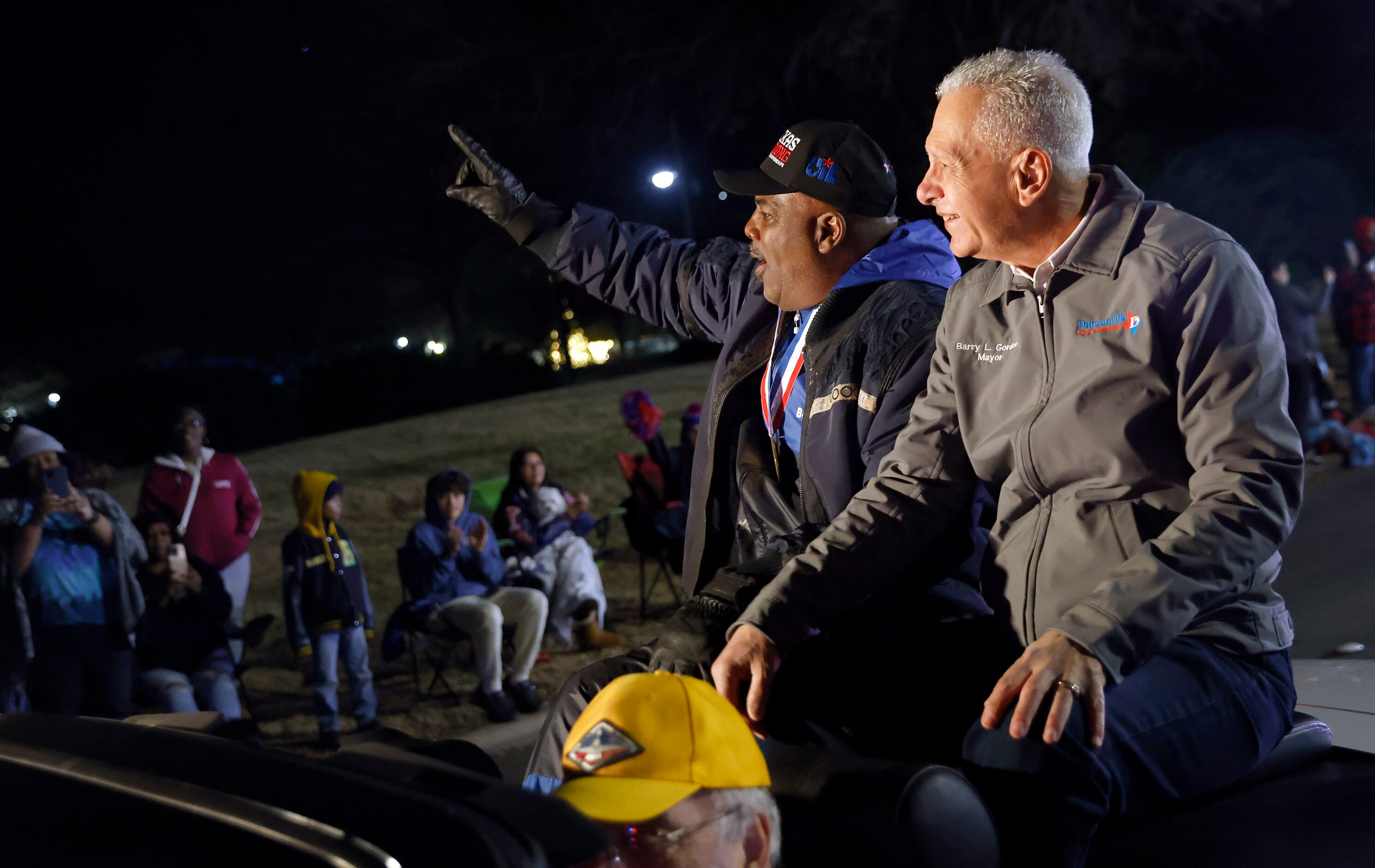 Duncanville High head football coach Reginald Samples (left) waves to fans as he rode in a...