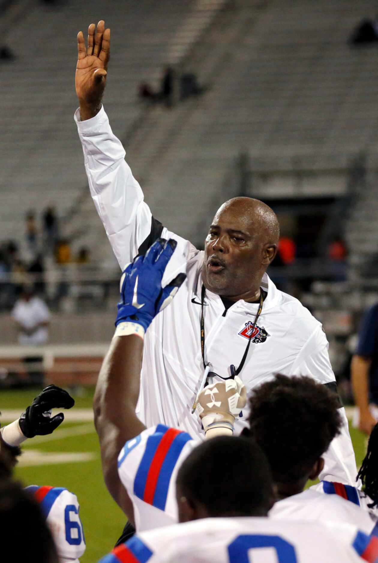 Duncanville head coach Reginald Samples gathers his players together for a postgame huddle...