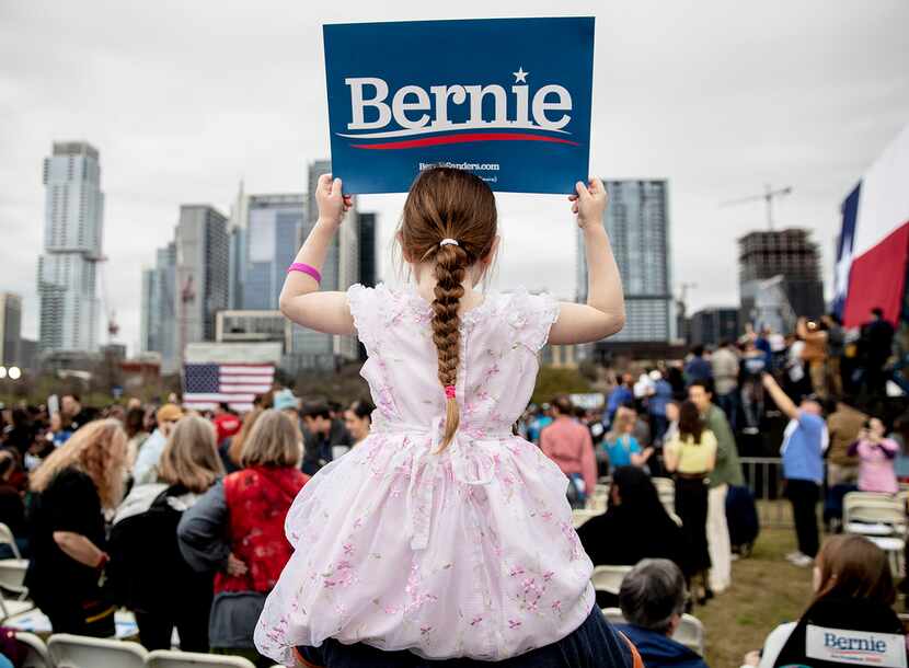 Lily Barbour, 5, holds up a campaign sign for Sen. Bernie Sanders, I-Vt., during a rally in...