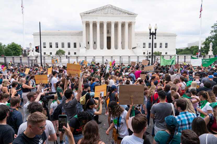 Protesters gather outside the U.S. Supreme Court on Friday, June 24, 2022, after the court...