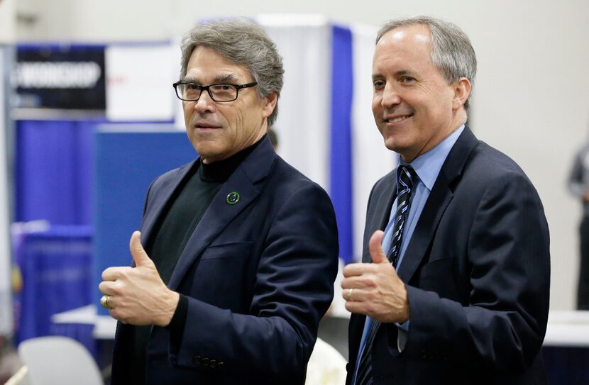 U.S. Secretary of Energy Rick Perry (left) had pushed Trump to renegotiate the Paris deal,...