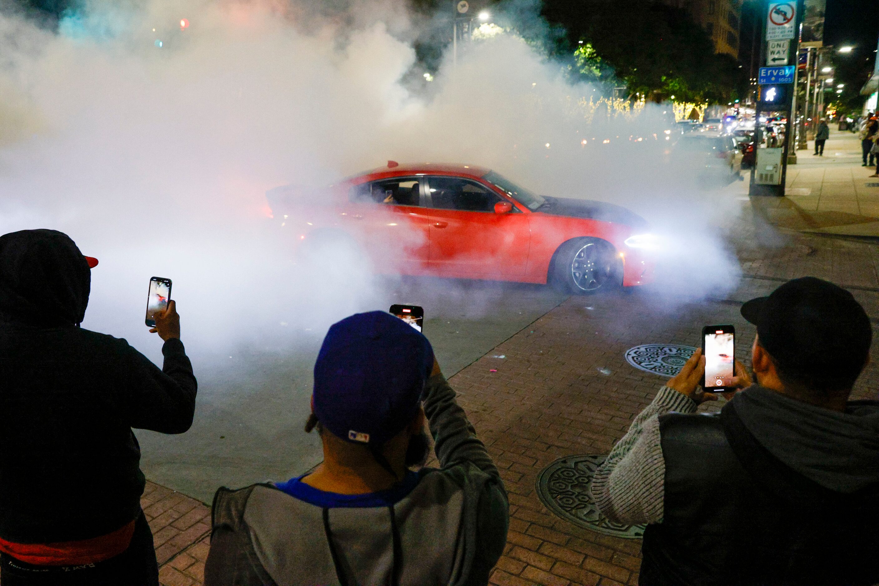 A car does donuts at Main and Ervay Streets after the Texas Rangers won the 2023 World...