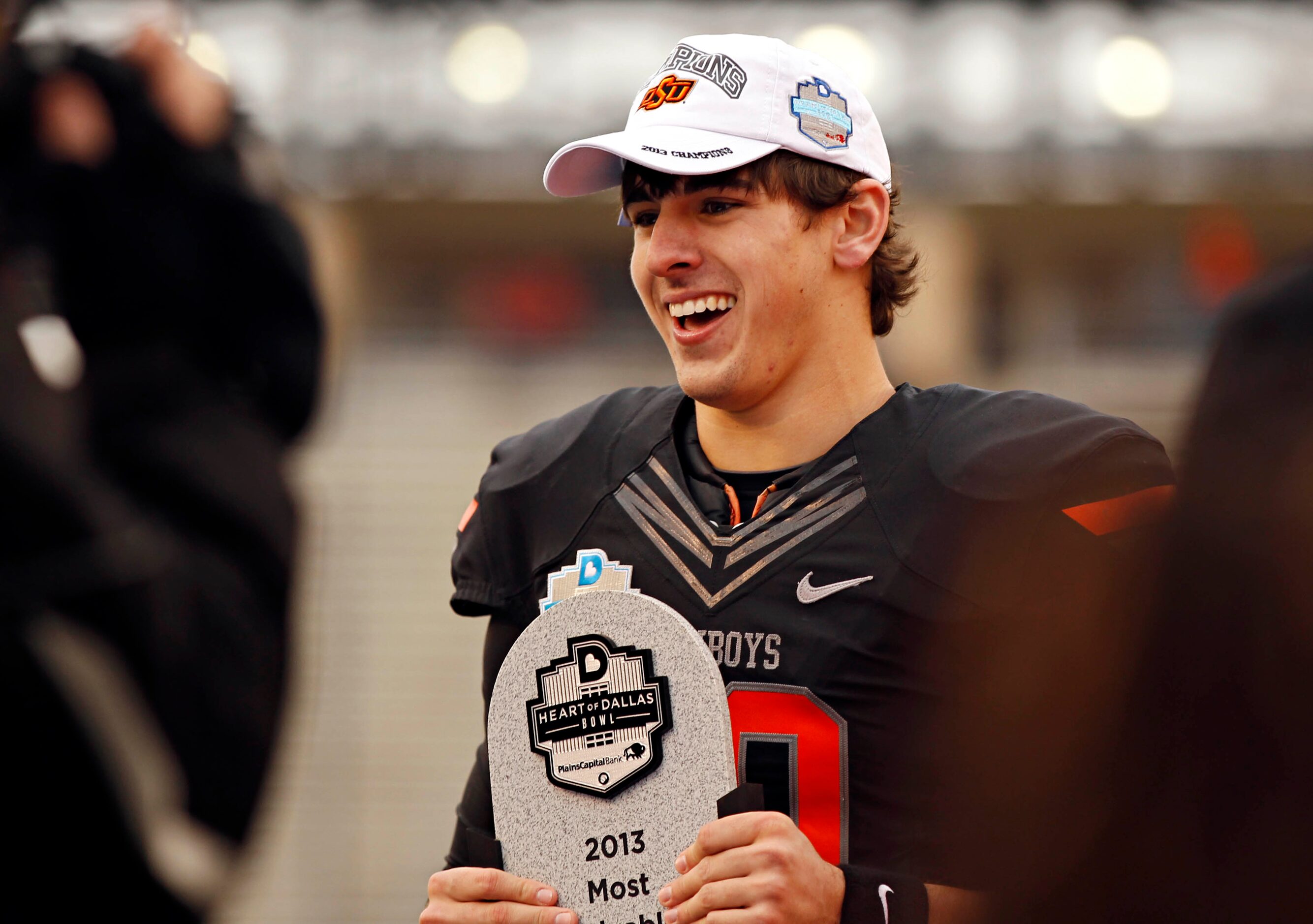 Oklahoma State Cowboys quarterback Clint Chelf (10) smiles as he is awarded most valuable...