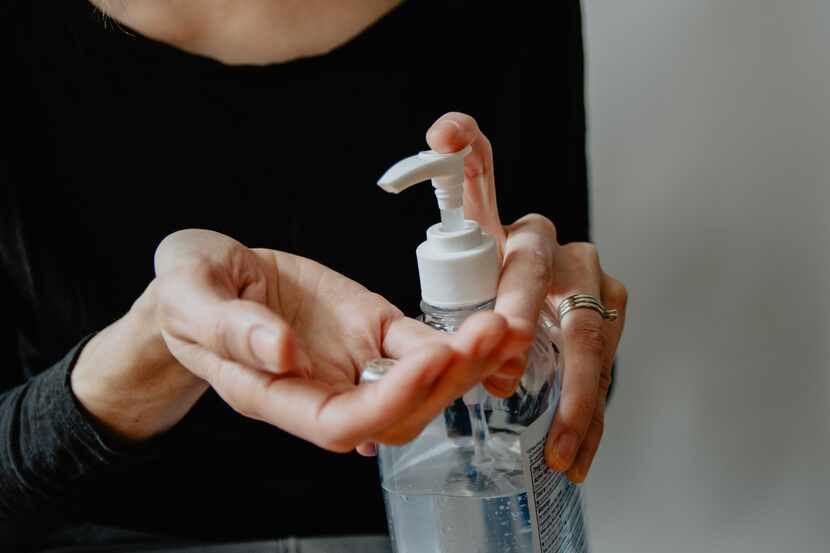 Women using hand sanitizer
