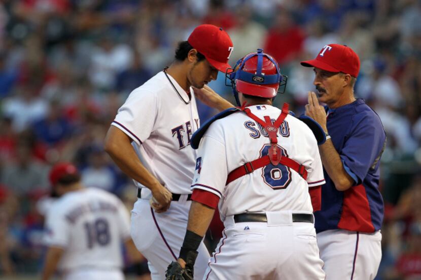 Texas Rangers pitching coach Mike Maddux (31) talks with Texas Rangers starting pitcher Yu...
