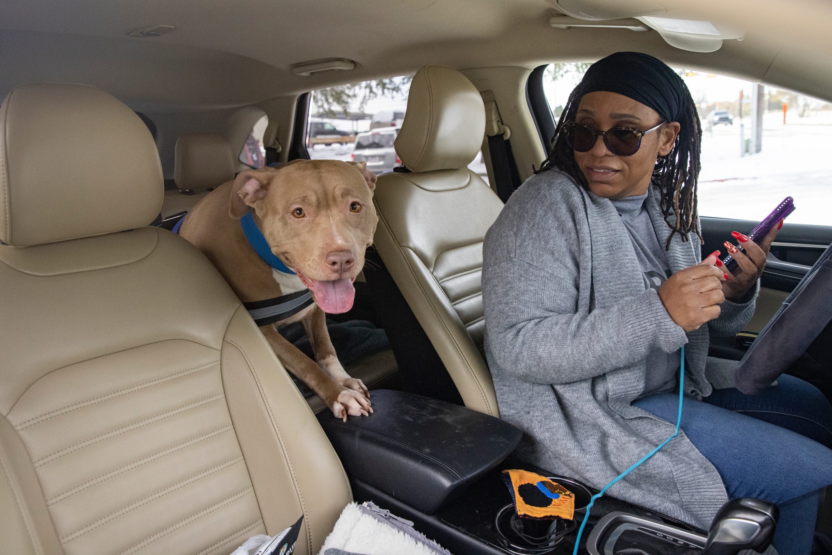 Patricia Ashford from Fort Worth with her dog Sigma makes phone calls after finding out the...